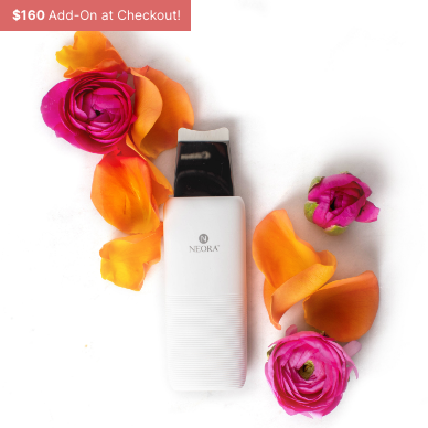 Neora’s NEW Ultrasonic Skin Renewal Facial Device amid a rose bouquet